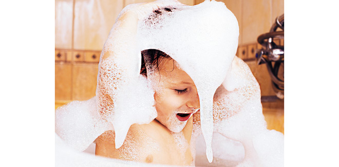 little cute boy in bathroom with bubbles close up