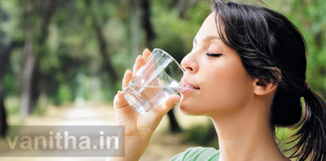 young woman drinking with waterglass