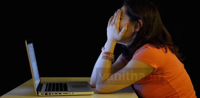 Young student woman alone at desk with computer crying desperate suffering