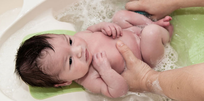 Newborn Baby Getting His First Bath 