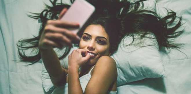 girl_in_bed_taking_selfie_getty_600