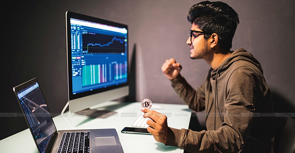 Indian trader with bitcoin checking stock trading data analysis concept working in office with financial graph on computer monitors